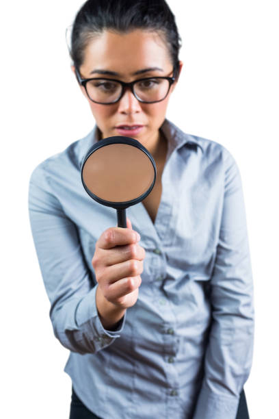 istock Woman examining with a magnifying glass 666388794