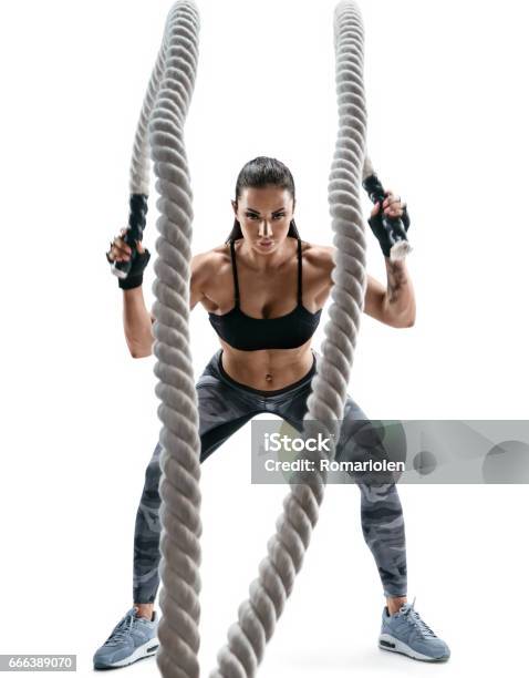 Strong Muscular Woman Working Out With Heavy Ropes Stock Photo - Download Image Now - White Background, Gym, Cut Out