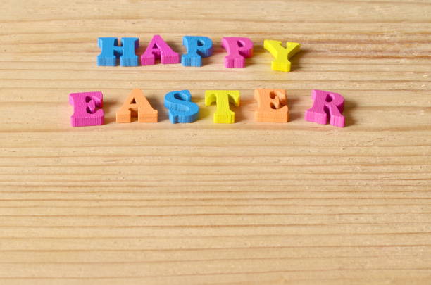 istock Happy Easter background. Greeting with colorful letters on a wooden background. 666390136