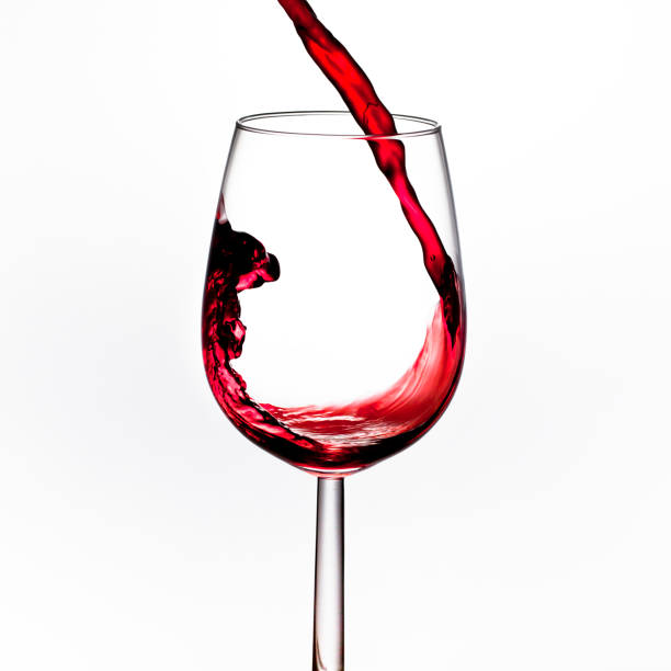 istock pouring red wine into a glass, close-up 666391314