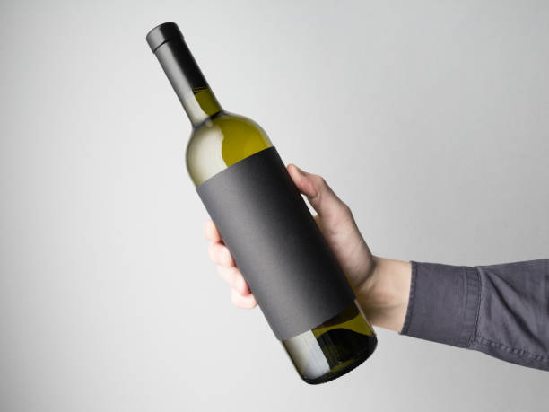 Hand is holding wine bottle stock photo