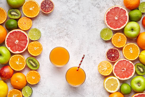 istock Fresh juices or smoothies with citrus fruit, apple, kiwi on light background. Top view, selective focus. Detox, dieting, clean eating, vegetarian, vegan, healthy lifestyle concept 666395598