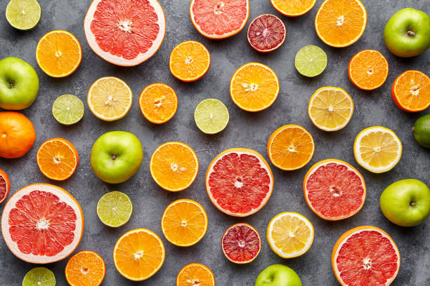 istock Citrus fruit pattern on grey concrete table. Fruit food background. Healthy eating. Antioxidant, detox, dieting, clean eating, vegetarian, vegan, fitness or healthy lifestyle concept 666396030