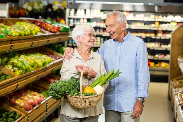 istock Smiling senior couple holding basket with vegetables 666396500