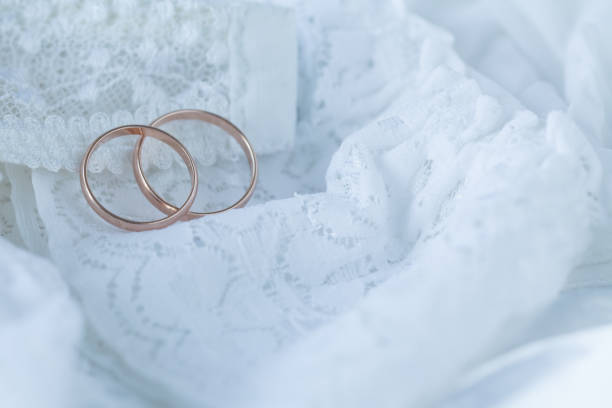 istock gold rings on white lace fabric 666397676
