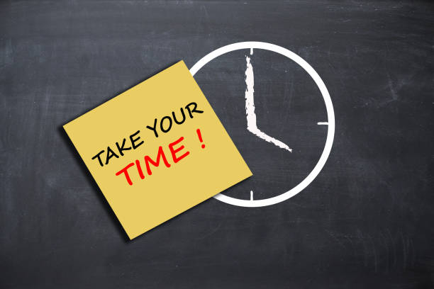 istock Take your time concept with alarm clock on school board 666397722
