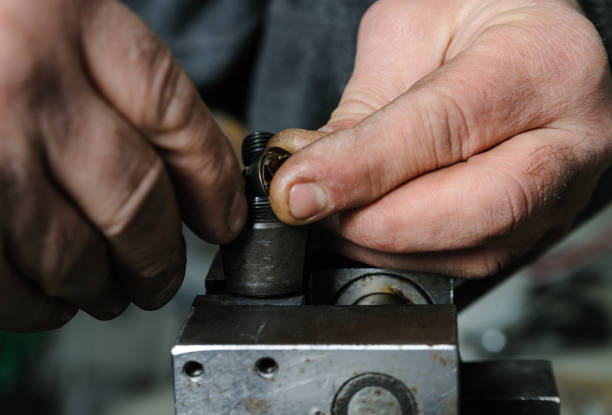 istock Mechanics repairing a diesel injector. 666397732