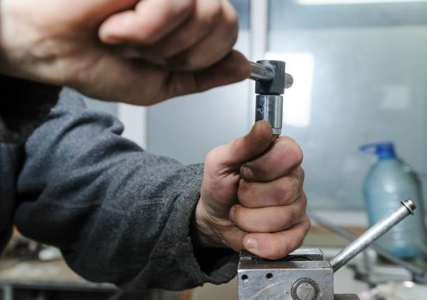 istock Mechanics repairing a diesel injector. 666397734