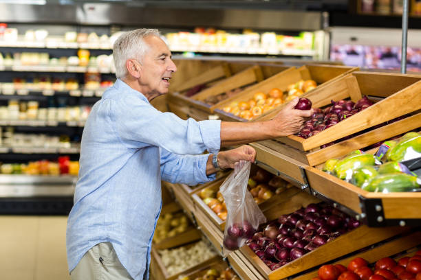 istock Senior man buying red onion 666398296