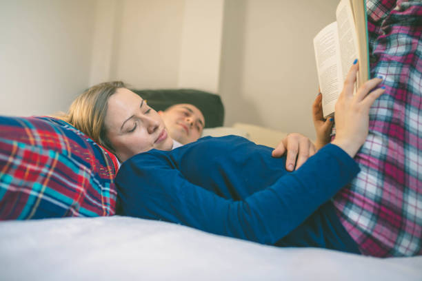 istock Happy couple relaxing together on their bed 666427312