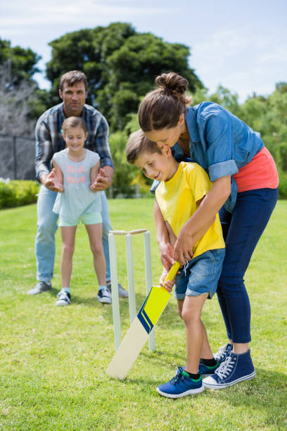 istock Family playing cricket in park 666467702