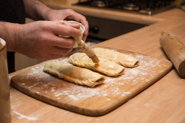 preparing and cooking sausage rolls with butter-rich pastrydients - sausagemeat imagens e fotografias de stock