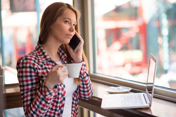 istock Hipster woman using phone and sitting in cafe 666470974