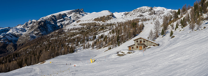 View over the Pennine Alps and its mountain hut during winter time.