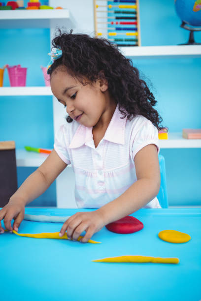 istock Cute girl playing with modeling clay 666475288