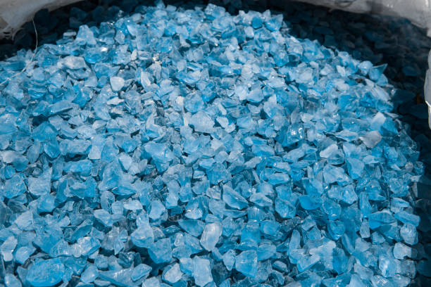 istock Small naturally polished blue crystal glass rock pebbles placed in a white bag background. Miami. Florida. USA 666476468