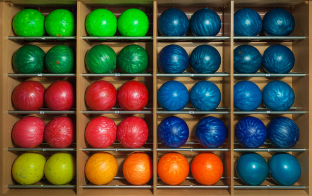 istock Bowling balls in the rack, sorted by size and color 666477556
