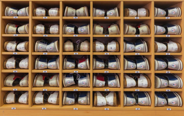Bowling shoes in a shoe cabinet sorted by size