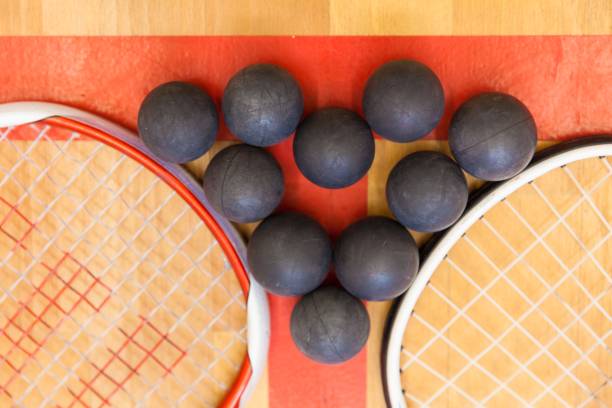 istock squash balls between two squash rackets on the court 666477652