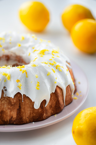 Closeup of a homemade lemon pound cake with fresh fruit.