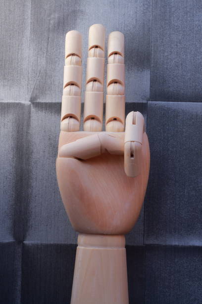 istock Wooden hand with three raised fingers 666486312