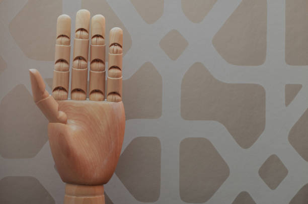 istock Wooden hand with five raised fingers 666486342