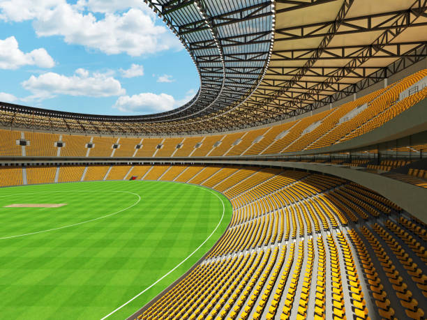 istock 3D render of a round cricket stadium with yellow  seats and VIP boxes 666486604