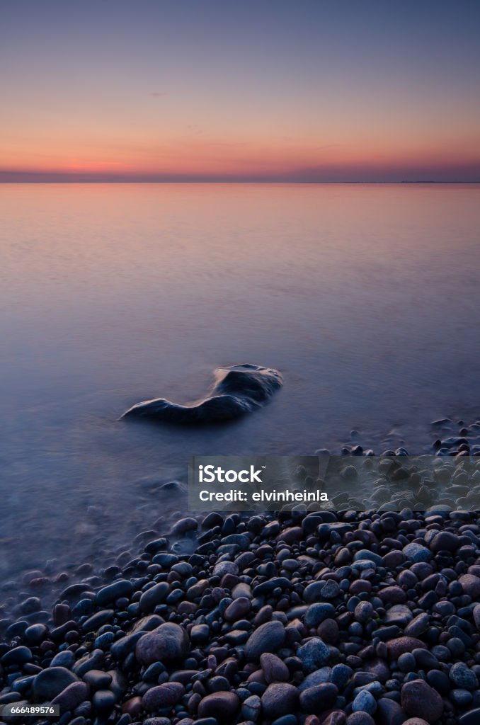 The first summer night at the rocky beach. The first summer night at the rocky beach. Peaceful and quiet while waiting for sunrise Backgrounds Stock Photo