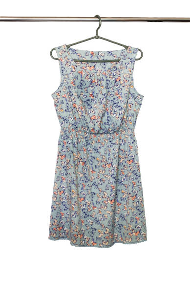 istock Summer dress with a butterfly pattern hanging on a hanger, isolated 666492948