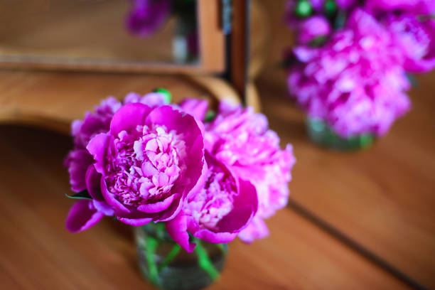 istock Pink peonies in a glass jar 666503230