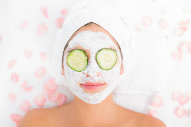istock Attractive woman having cucumber on her face 666503678
