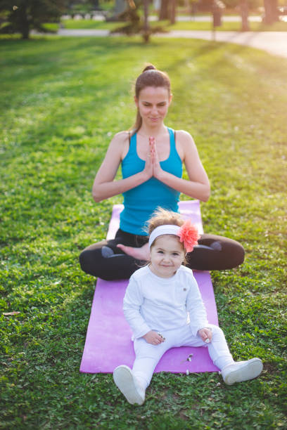 istock Sporty woman practicing yoga with child 666504154