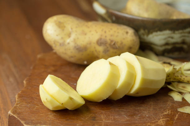 istock Potatoes and potato sliced on wooden table. Selective focus 666506624