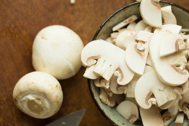 istock Champignon mushrooms on the wooden table. Selective focus 666506694