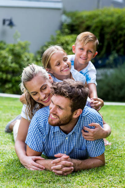 istock Happy family enjoying on grass in yard 666507046