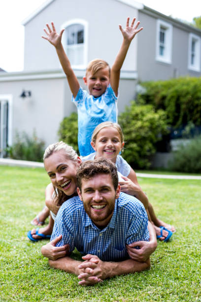 istock Boy with arms raised with family in yard 666507076