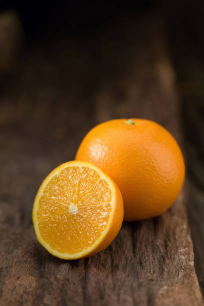 istock fresh orange and orange slices group on a dark wooden table 666510058
