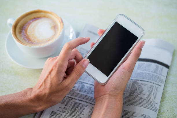 istock Woman having cappuccino using her phone 666510230