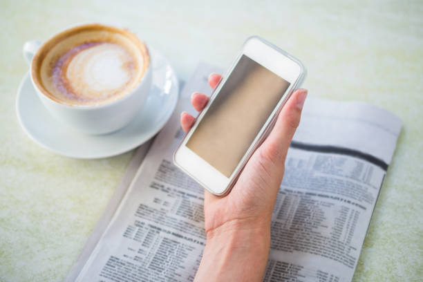 istock Woman having cappuccino using her phone 666510256