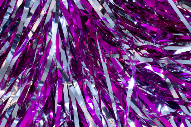 This is a closeup photograph of Cheerleader silver and purple pom poms