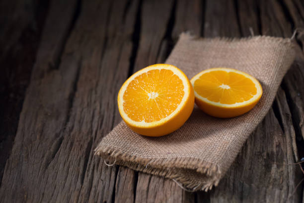 istock fresh orange and orange slices group on a dark wooden table 666510780