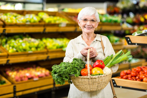 istock Senior woman holding wicker basket 666524996