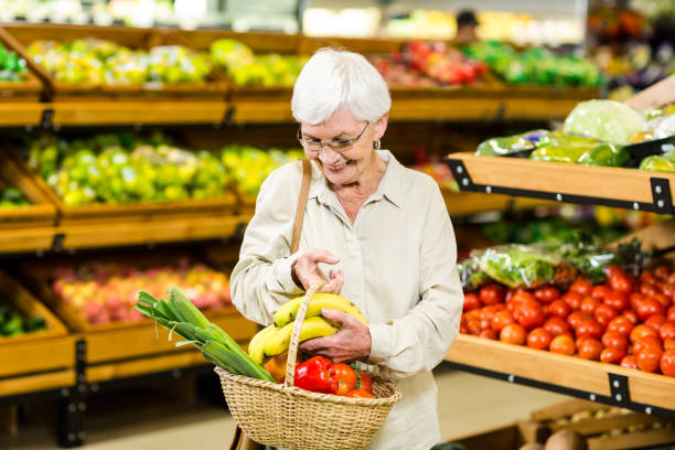 istock Senior woman holding wicker basket 666526788