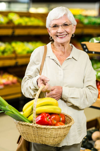 istock Senior woman holding wicker basket 666526844