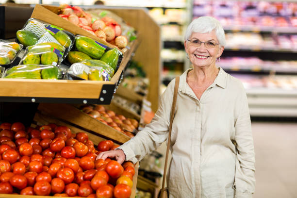 istock Senior woman choosing her tomatoes 666526920