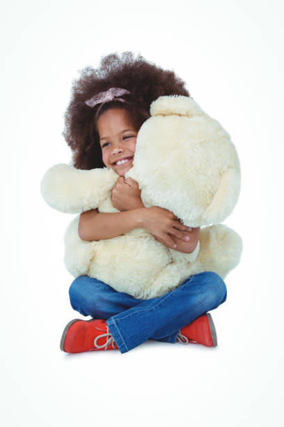 istock Cute girl sitting on the floor hugging teddy bear 666527142