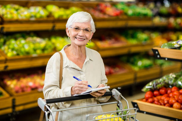 istock Smiling senior woman checking list 666527306