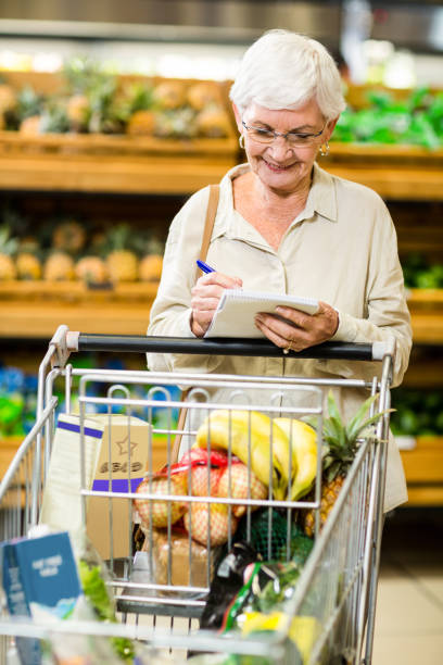 istock Smiling senior woman checking list 666527392