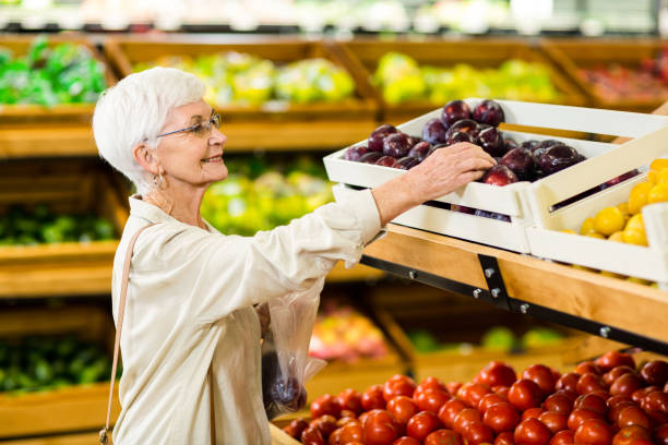 istock Senior woman holding bag with apple 666529442