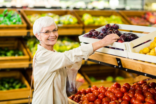 istock Senior woman holding bag with apple 666529484